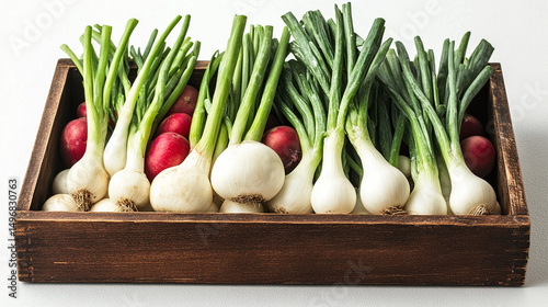 Freshly harvested spring onions and radishes arranged in a wooden box with a clean background