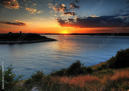 Majestic Seascape at Sunset with Horizon Illumination and Coastal Vegetation