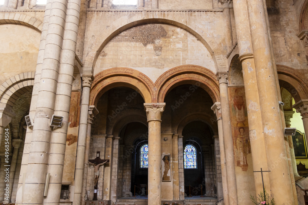 Fototapeta premium Interior view of Poitiers Cathedral showing arches, columns, and stained glass windows