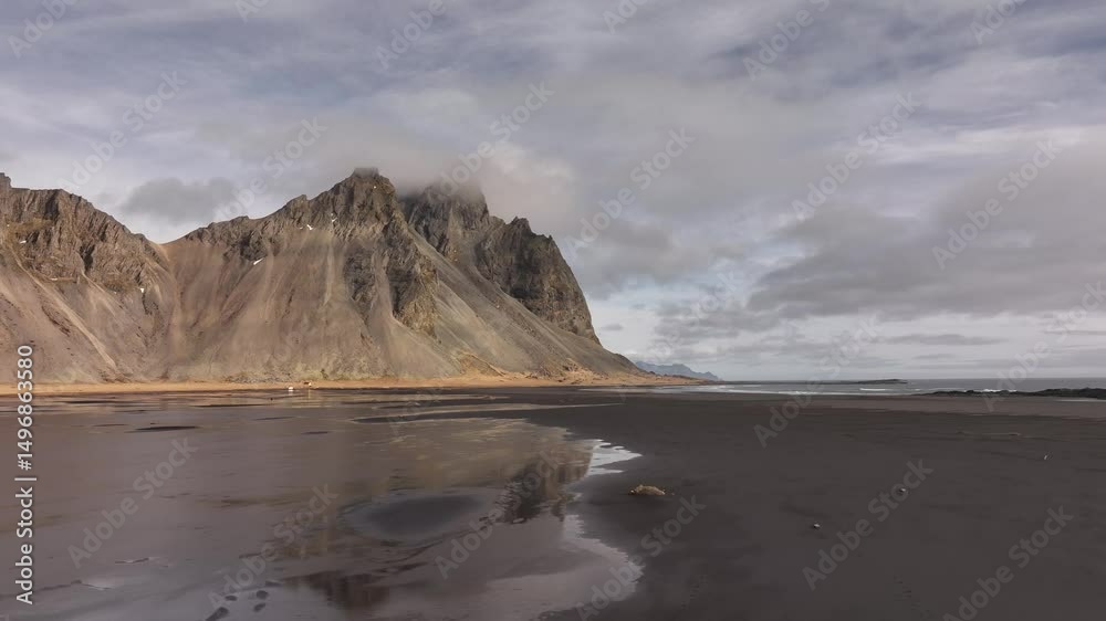Vestrahorn, Eystrahorn and Brunnhorn mountains aerial view over Stokksnes' black sand beaches, Iceland's coastal beauty. Vestrahorn, Eystrahorn and Brunnhorn mountains aerial view over Stokksnes' black sand beaches, Iceland's coastal beauty.