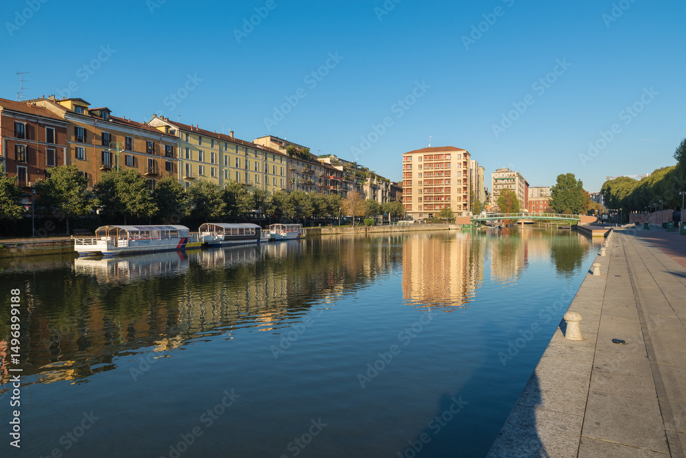 Obraz premium Milan city, Italy. Sunrise at the Darsena. A very popular area of ​​Milan both during the day and at night due to the presence of bars, cafes and restaurants. Porta Ticinese area
