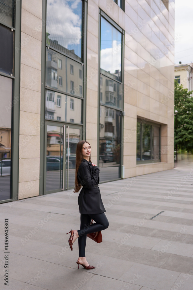 © OLGA RA - Beautiful girl in patent burgundy shoes against the background of a business center. © OLGA RA - Beautiful girl in patent burgundy shoes against the background of a business center.
