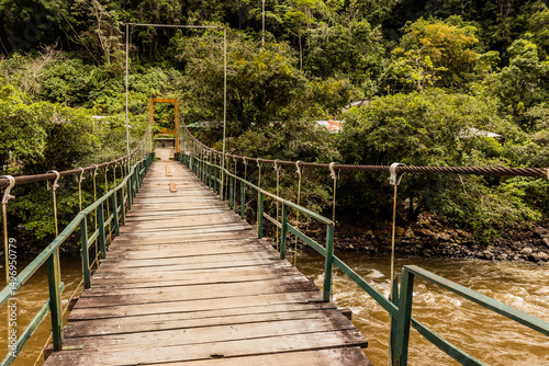 Hanging bridge over Huallaga river near Catarata Gloriapata waterfall in Tingo Maria national park, Peru