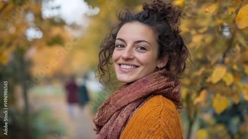Smiling Woman with Curly Hair in an Autumnal Outdoor Scene