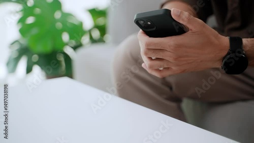 Man's hand presses the unlock button on the phone and turns it over on the table to turn it off, screen time control, reduce social networking, social detox.