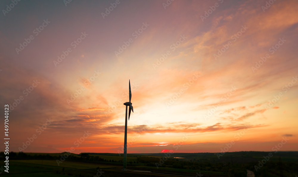 Obraz premium Green energy helps reduce carbon emissions and makes the earth cleaner and more ecological.Ecology technology industrial.Aerial view of windmill turbines generating green energy electricity at sunset.