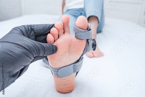 Leg with hallux valgus deformity of big toe in orthopedic bandage in orthopedist