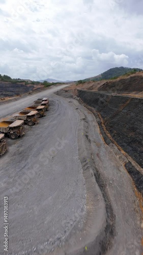 Open-pit gold and silver mine, Barrick Gold, Cotui, Dominican Republic. Aerial drone FPV. Vertical format, copy space photo