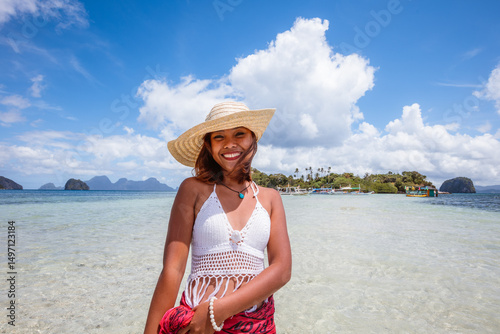 Portrait of young filipino woman smiling at camera, at the beach, El Nido, Philippines
