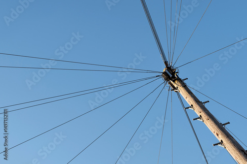 A telegraph pole carrying telephone cables to suburban houses in a town in the UK. 