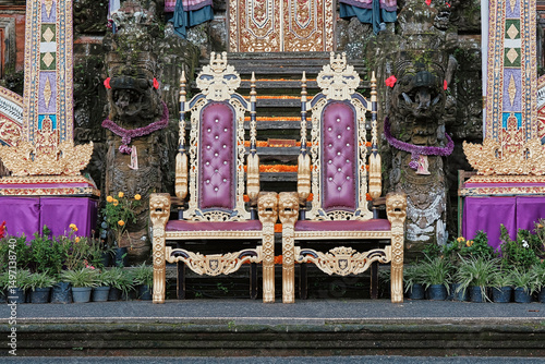Elaborate throne chairs at a Balinese temple with colorful decorations in Indonesia