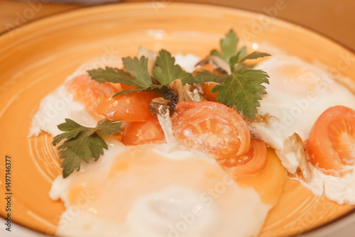 Fried eggs with tomato, mushroom, and parsley served on a plate for a healthy breakfast. Natural and fresh food concept.