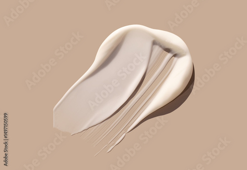 sample smear of creamy white texture on light beige background close up