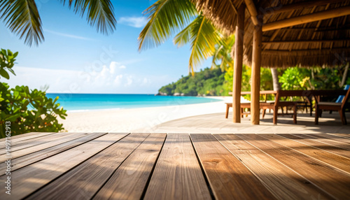 Tropical beach with palm trees, sun loungers, and turquoise sea under a clear blue sky.