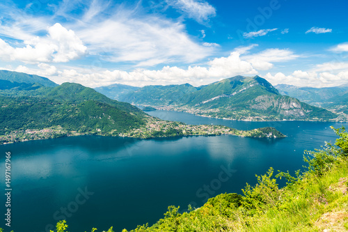 Panorama of Lake Como photographed at Alpe Mezzedo in Esino Lario, showing Bellagio, Balbianello, the Lecco and Como shores of the lake and the mountains above.
