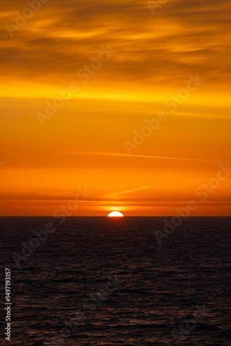 Stunning ocean sunset with vibrant orange hues.