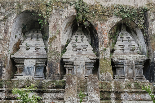 Ancient stone carvings at Gunung Kawi in Bali showcasing intricate architectural details and lush surroundings