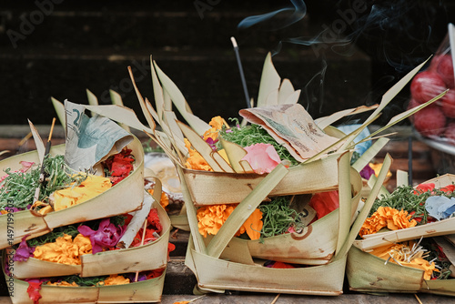 Colorful offerings displayed in traditional baskets at a Balinese temple in Indonesia during a serene morning ceremony