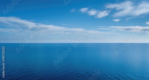 Vast ocean and sky view, with calm waters and a partially cloudy sky. The scene captures the tranquility of the sea and the openness of the sky.