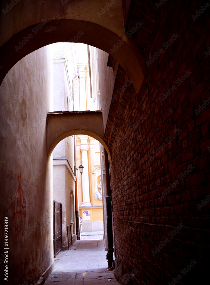 alley in the old town in Warsaw, gate between tenement houses