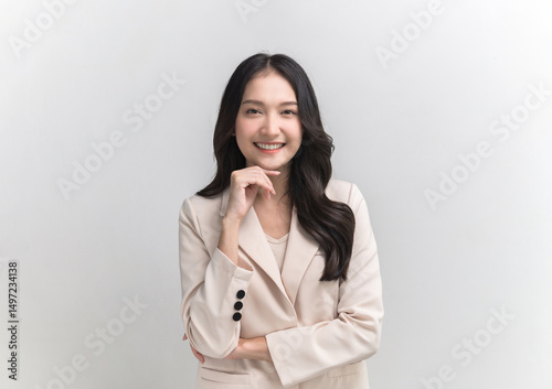 Studio portrait photo of young beautiful Asian woman in formal suit dressing with confident and luxury looking and attractive on white background studio shot.