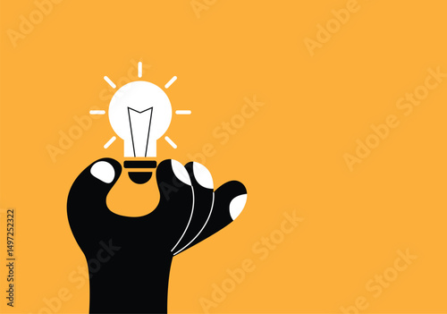 Abstract Black Hand Showing a Light Bulb. Technology and electricity, bright idea generation and success in business