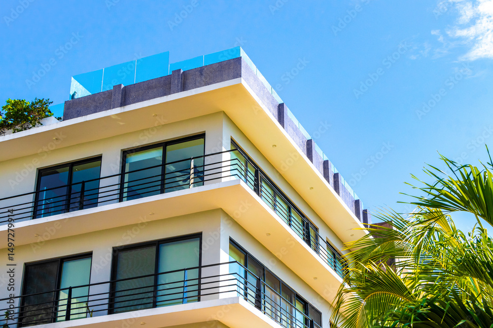 Obraz premium Modern buildings architecture hotels apartments palm Playa del Carmen Mexico.