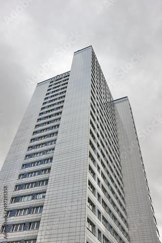 Tall office building against cloudy sky