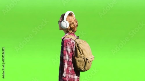 Modern Melodies: A young person, immersed in a personal soundtrack, strolls through a vibrant green expanse, radiating a sense of calm and connection.