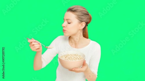 Healthy Breakfast Delight: A young woman savoring a wholesome meal from a bowl, demonstrating the joys of a balanced, nutritious breakfast. The scene is set against a bright, vibrant backdrop.