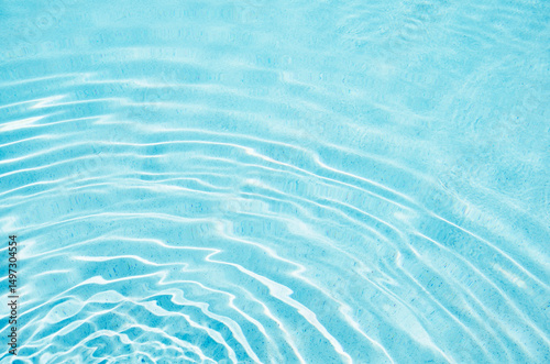 Ripples on turquoise pool water surface
