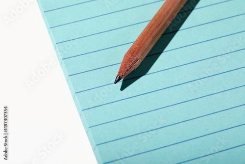 Pencil on pad of blue line paper