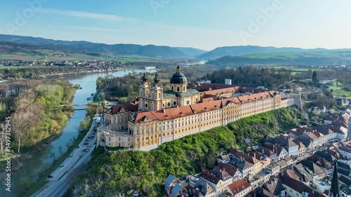 Melk in Lower Austria. Old town with active Benedictine abbey and monastery in Baroque style on the rocky hill and Danube river. Aerial drone 4K video