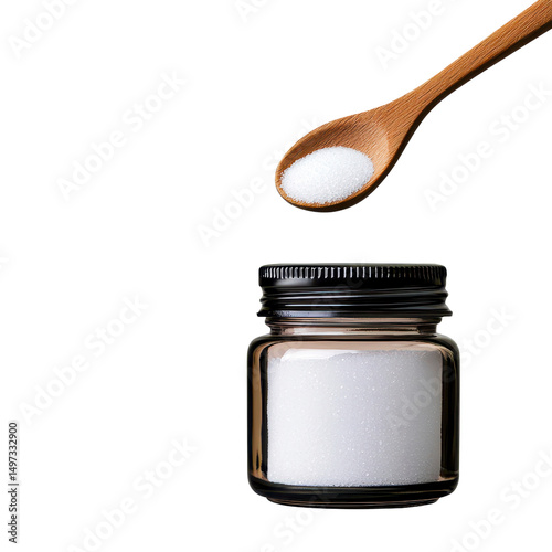 Spoonful of sugar above a jar of white sugar isolated against a transparent background..