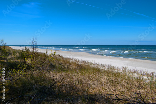 Fototapeta Naklejka Na Ścianę i Meble -  Empty beach of the Baltic Sea with white sand, Lubiatowo, Poland. Seascape with waves.
