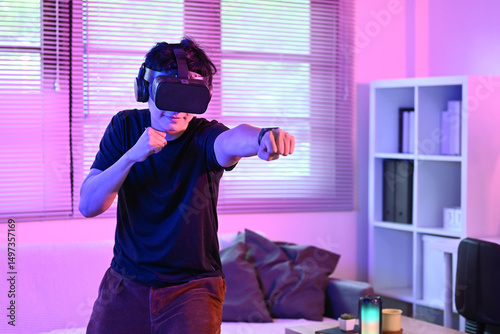 Young Asian athletic man energetic workout by boxing in virtual reality environment, combining technology and fitness at modern home.