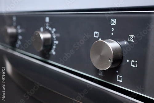 Canvas Print Digital kitchen oven with convection mode and temperature selectors on gas cooker hob stove selective focus close up shot