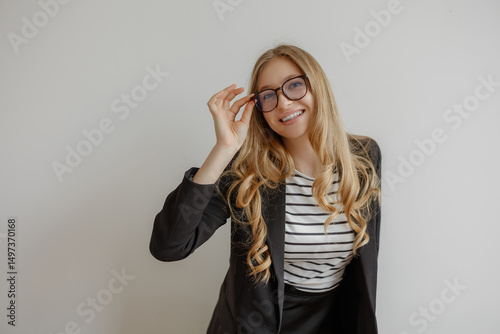 Wallpaper Mural Confident woman in business attire smiling while adjusting her glasses indoors Torontodigital.ca