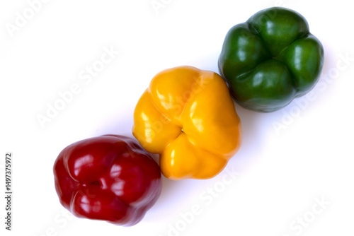 Red, yellow, and green bell peppers arranged in a line. A vibrant, healthy trio representing summer, freshness, nutrition, and clean eating with a soft light aesthetic.