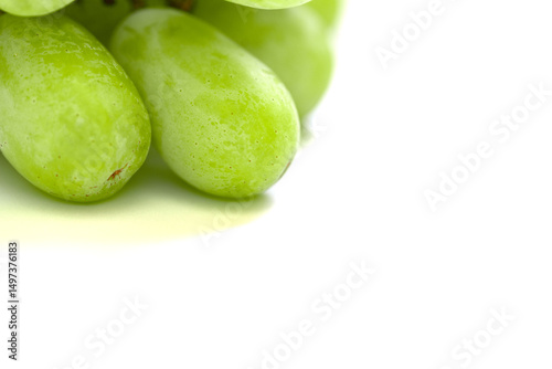 Macro shot of two large green grapes and one tiny grape on a white background. A playful, natural still life symbolizing growth, beauty, and summer fruit freshness.