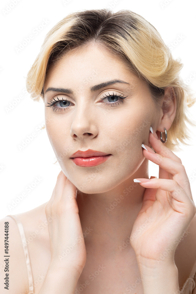 Fototapeta premium A young blonde girl with clear skin in a satin top. Beauty portrait of a woman on a white background in the studio.