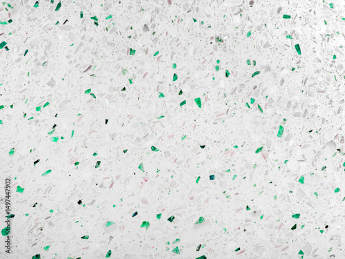 Bianco green Terrazzo surface, characterized by a predominantly white base speckled with numerous irregular chips and fragments of green glass. modern terrazzo background.