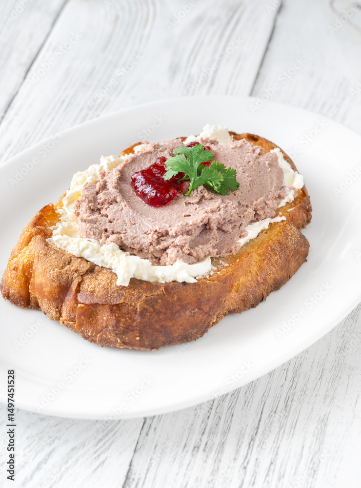 Gourmet sandwich layered with pate, cranberry jam, and cream cheese Gourmet sandwich layered with pate, cranberry jam, and cream cheese