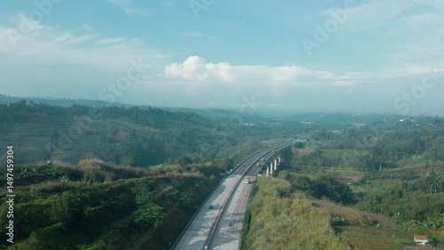 4K UHD Drone Shot of Highway Bridge Through Lush Hills

