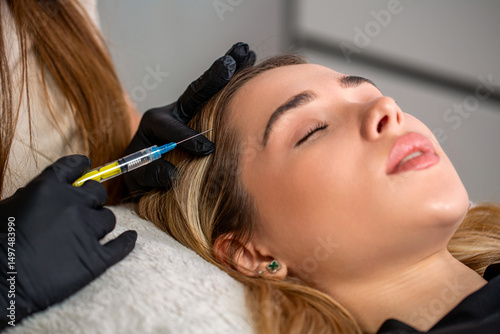 Hair strengthen and growth, needle mesotherapy. Woman getting cosmetics injection in head, copy space. Young woman with hair loss problem receiving injection. Hair loss, alopecia treatment, prp