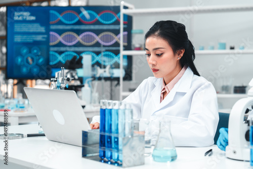 Confident female scientist focused on research in a biotechnology lab, symbolizing women empowerment in science, innovation, and leadership in the field of modern genetics.