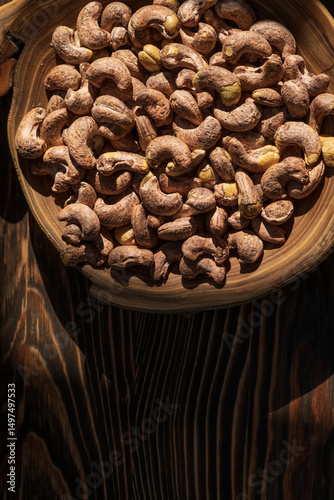 Dish of cashew nuts on the wooden bowl