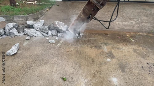 Excavator Breaking Concrete Pavement – Roadwork Construction in Urban Area