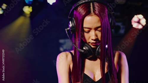 Stylish Female DJ Mixing at Nightclub – Cinematic Loop with Pink Lights, Headphones, and DJ Controller | 4K Video Background
