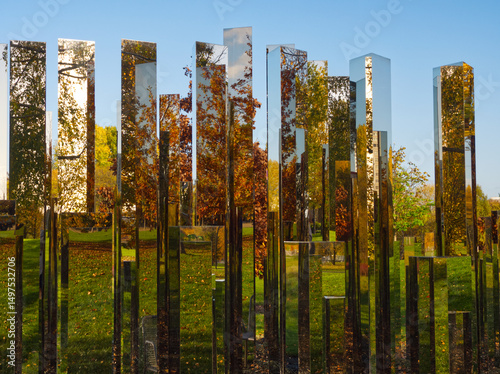Berlin, Germany - November, 03, 2020. Installation Reflecting Gardens (Gärten der Welt). Mirror geometric pillars with surrounded landscape reflections. Contemporary art, mirror labyrinth. Autumn view